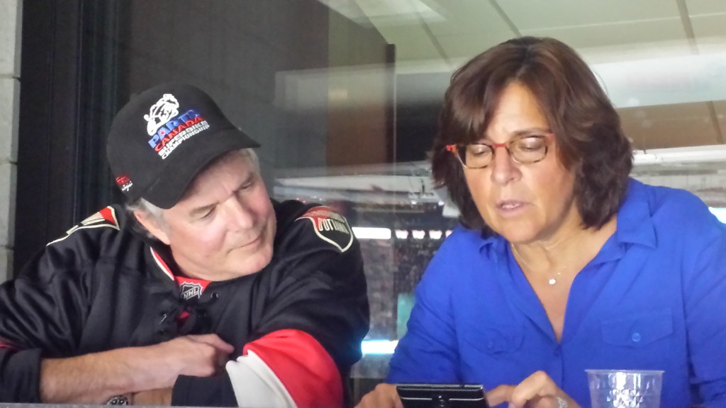 Bruce Gregory and Debbie Weinstein finalizing the details at a Sens game!